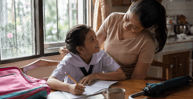 Filipino mom and child at home during a rainy school day